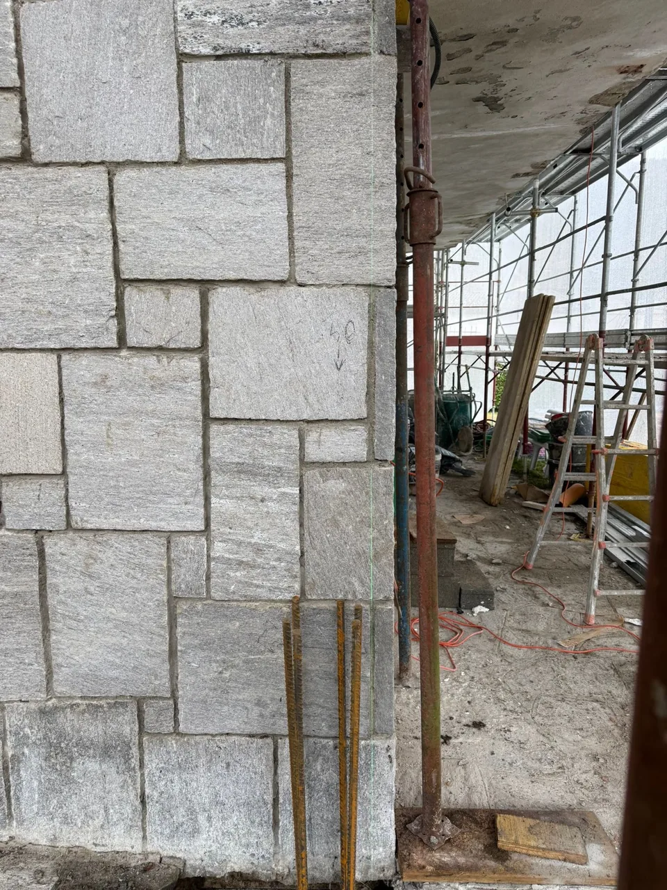 Stone cladding on a scaffolded facade