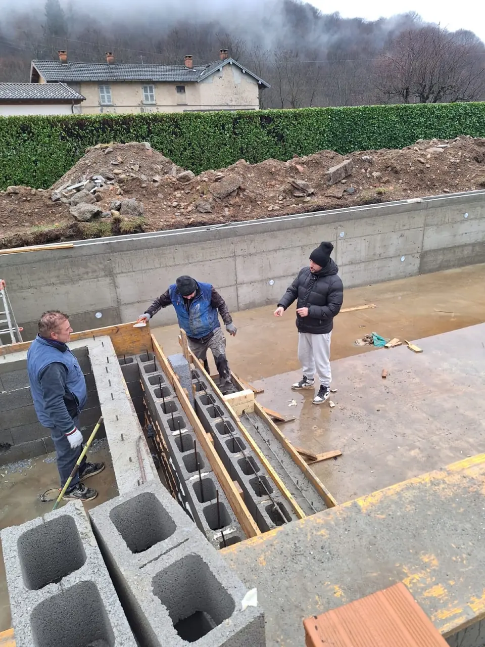 Team working on a concrete block wall